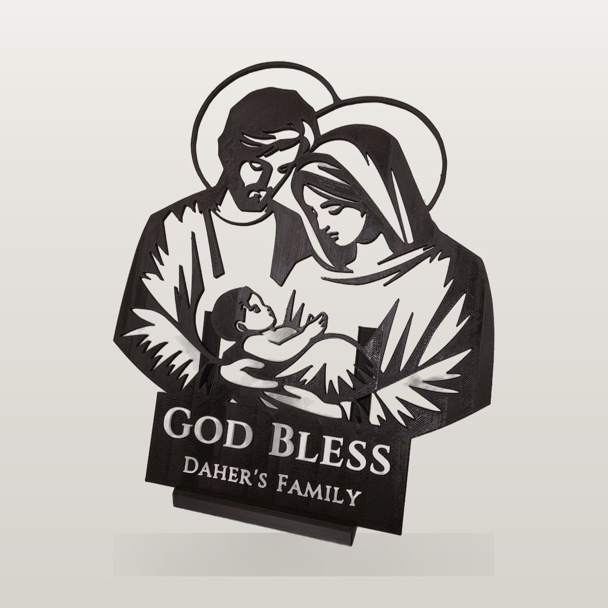 Black 3D printed Holy Family silhouette on a stand, with a plate reading God Bless Daher's Family