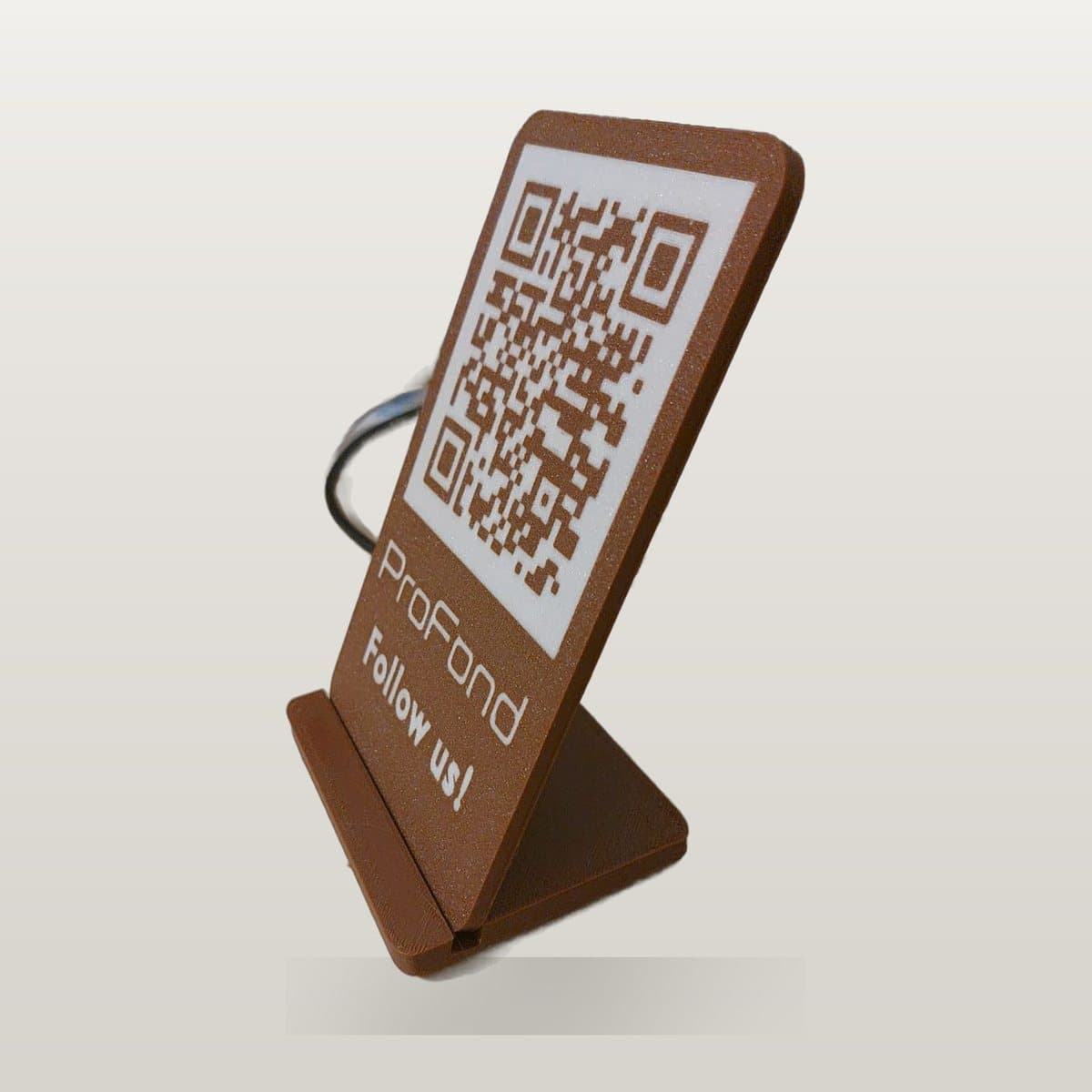 Brown 3D printed desk stand with a white QR code panel reading ProFond, Follow us